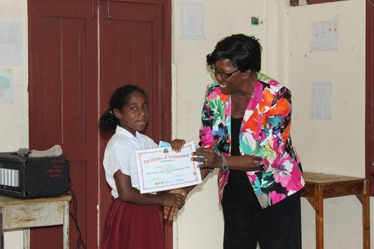 HFLE Education Officer_Hermonine Baptiste hands out certificate to Mt Rose SDA student